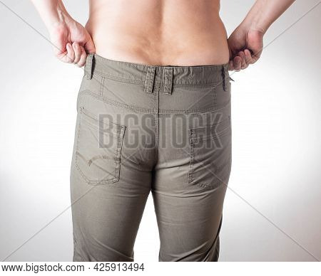 A Fat Man With Overweight And Fat Folds On His Stomach Wears Small Green Shorts On A White Backgroun