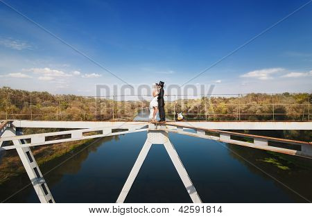 Bride And Groom On The Bridge