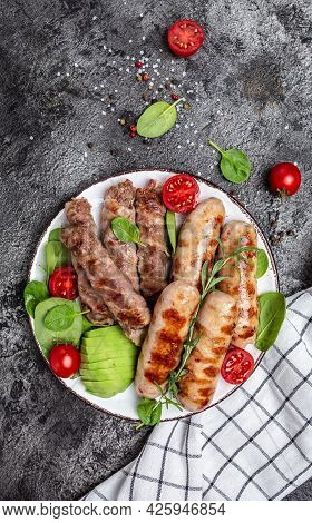 Grilled Munich Veal Sausages And Meat Rolls Wrapped Bacon, Chevapchichi Or Kofta Kebab. Ketogenic Di