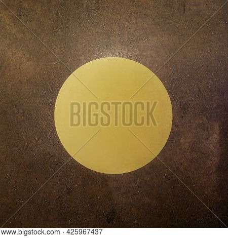 Round yellow sign on a brown background