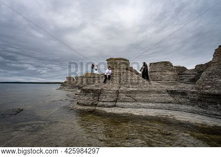 June 6, 2021 - Borgholm, Sweden: People Enjoy Beautiful Limestone Formations With A Dramatic Sky In 
