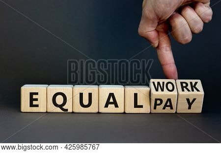Equal Pay And Work Symbol. Businessman Turns Wooden Cubes And Changes Words Equal Pay To Equal Work.