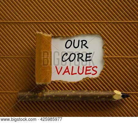 Our Core Values Symbol. Words 'our Core Values' Appearing Behind Torn Brown Paper. Wooden Pencil. Be