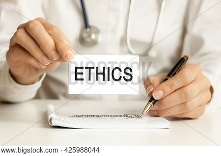 Doctor's Hands A Sheet Of Paper With Text Ethics, Medical Concept