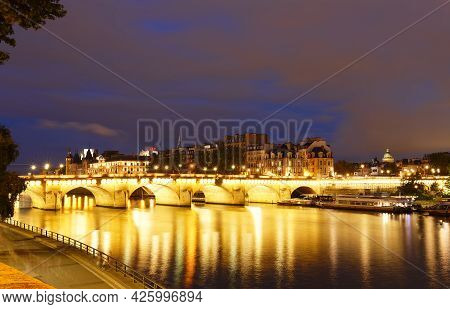 Cityscape Of Downtown With Pont Neuf Bridge And River Seine At Night , Paris .