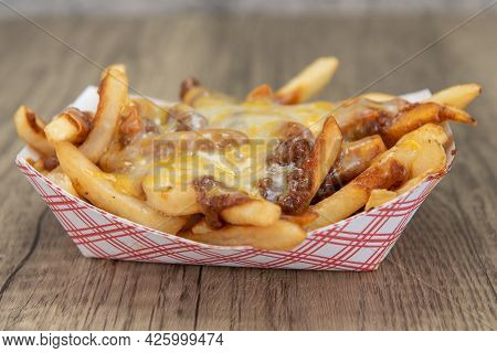 Melted Cheese Smothers This Entire Boat Of Chile Cheese French Fries As A Very Filling Side Dish.