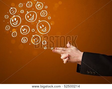 Group of happy hand drawed smiley faces coming out of gun shaped hands