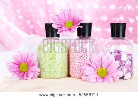 Aromatherapy minerals - colorful bath salt on pink background