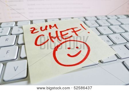 a sticky note is on the keyboard of a computer as a reminder: for chief