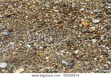 Wet pebblestones on sea beach