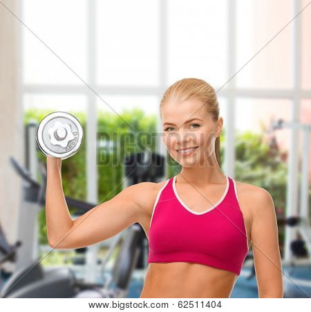 fintess, healthcare and dieting concept - young sporty woman with heavy steel dumbbell