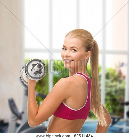fintess, healthcare and dieting concept - young sporty woman with heavy steel dumbbell
