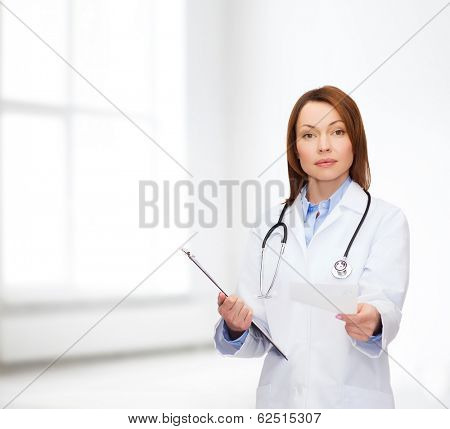 healthcare and medicine concept - calm female doctor with clipboard and stethoscope