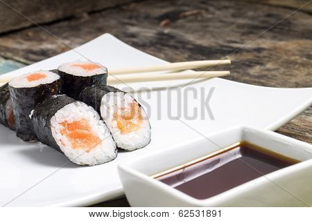 Makisushi On White Plate. Seafood Traditional Maki Sushi Rolls With Chopsticks