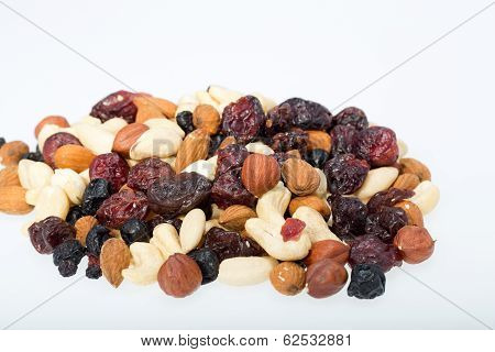 mixed nuts and dried fruits isolated on white background