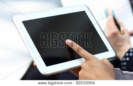 Business woman hand touching screen on modern digital tablet pc.