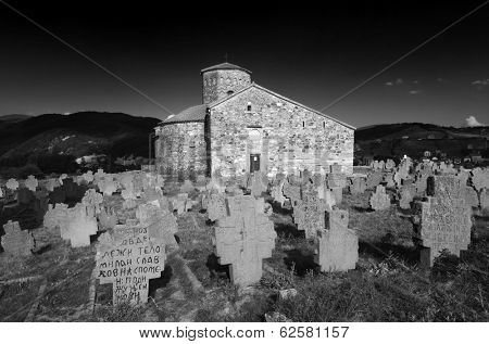 NOVI PAZAR, SERBIA - 26 July: historical cemetery and 9th century Serbian Orthodox Church of Holy Apostles St. Peter and St. Paul on July 26, 2013. UNESCO World Heritage Site since 1979