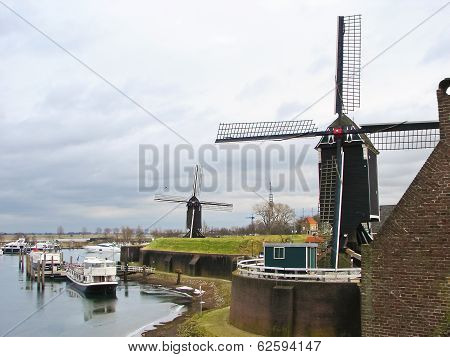 Ships and windmills in the port city Heusden. Netherlands