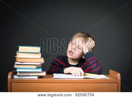 Child with learning difficulties. Tired boy doing homework. Education. Boring Studies. So tired of H