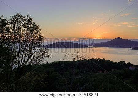 Sunset on the sea with the foggy mountains. Sunset over Budva, Montenegro