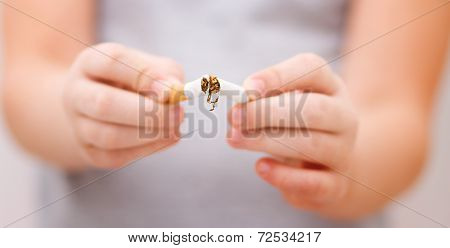 Young Girl Is Breaking A Cigarette