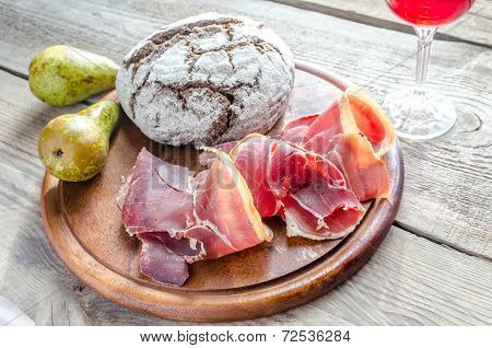 Slices Of Italian Ham On The Wooden Board