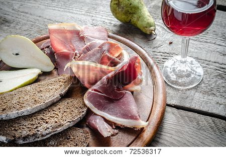 Slices Of Italian Ham On The Wooden Board