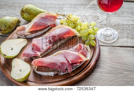 Sandwiches With Italian Ham On The Wooden Board