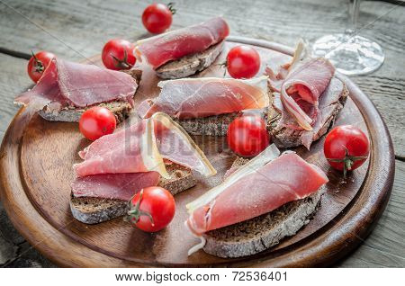 Sandwiches With Italian Ham On The Wooden Board