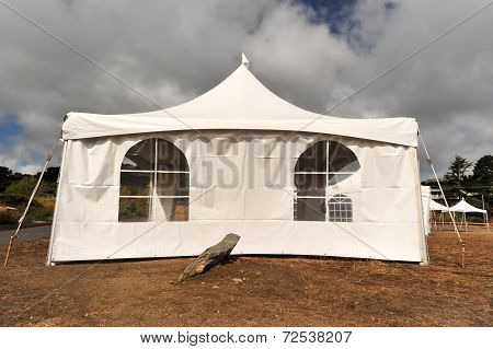 White Tents In A Dry Field Outdoors