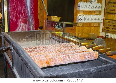 Traditional czech trdelnik baking on a street stand of Prague
