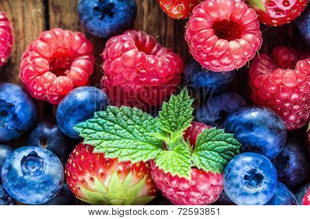 Berry fruits on wooden background
