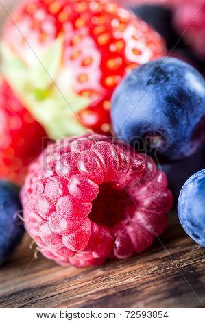 Berry fruits on wooden background