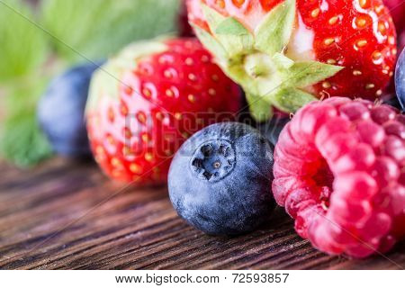 Berry fruits on wooden background