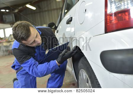 Mechanic checking on auto bodywork