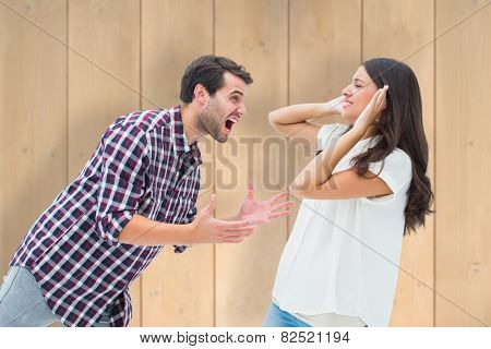 Fearful brunette being overpowered by boyfriend against wooden planks