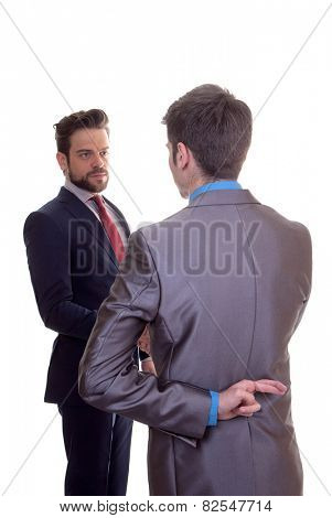 business men shaking hands fingers crossed because of hope or lie
