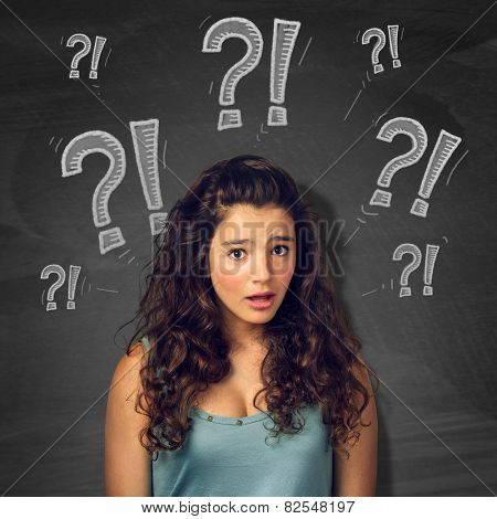 Pretty teenager girl with surprised expression over blackborad with signs
