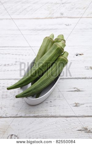 fresh lady finger on thw wooden table