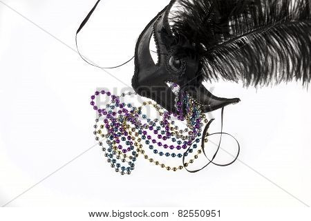 Shiny Gold, Purple, Blue And Silver Beads And Mardi Gras Mask With Feathers On A White Background. S