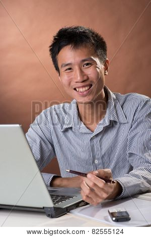 Successful business man of Chinese sitting, closeup portrait in studio.