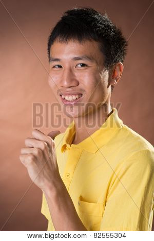 Cheerful young Chinese guy pointing at himself, closeup portrait in studio.