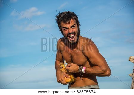 Strong Latin Male Survivor Opening A Coconut.