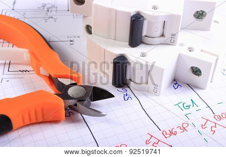 Metal Pliers And Electric Fuse On Construction Drawing