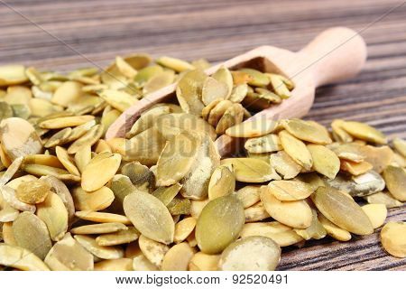 Pumpkin Seeds With Spoon On Wooden Background