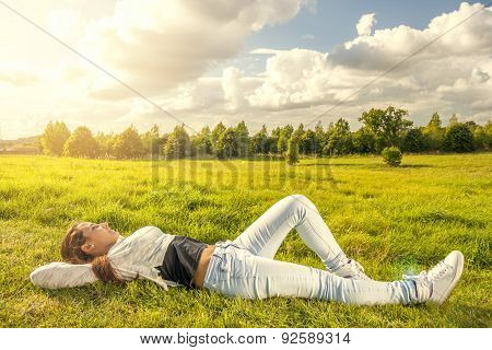 Beautiful Teenager Lying On The Grass