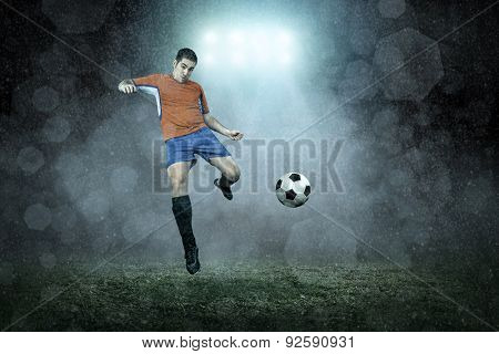 Soccer player with ball in action outdoors