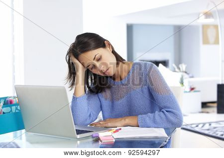 Stressed Woman Working At Laptop In Home Office