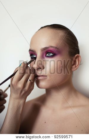 Makeup Artist Applies Eye Shadow. Beautiful Woman Face. Perfect Makeup