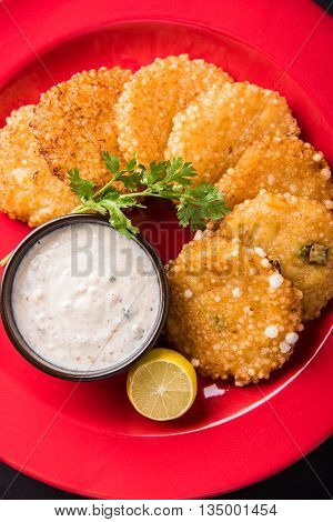 tasty sabudana vada or sabudana vade made up of Sago served with peanut chutney, a famous fasting recipe or snack from maharashtra, India